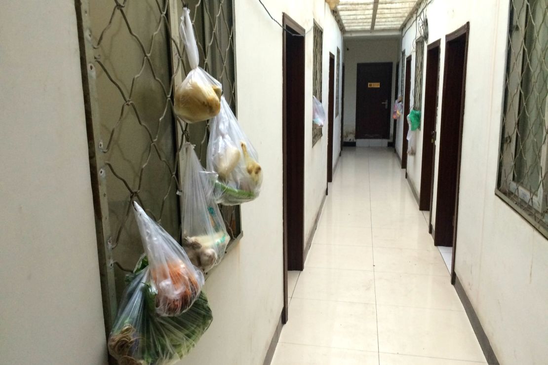 Bags of produce hang on the window frames each room. Many guests use communal kitchen to cut costs. 