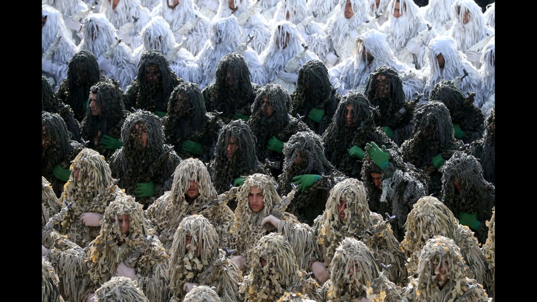 Iranian army troops wearing ghillie camouflage suits participate in the parade just outside Tehran, Iran.