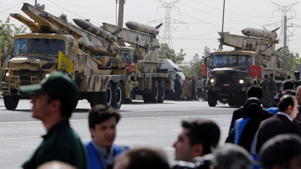 Mid-range Zelzal missiles are driven through the parade outside Tehran.