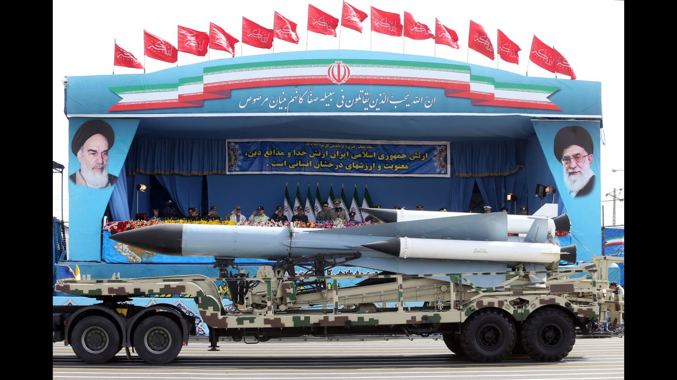 Missiles are paraded past Rouhani and military leaders.