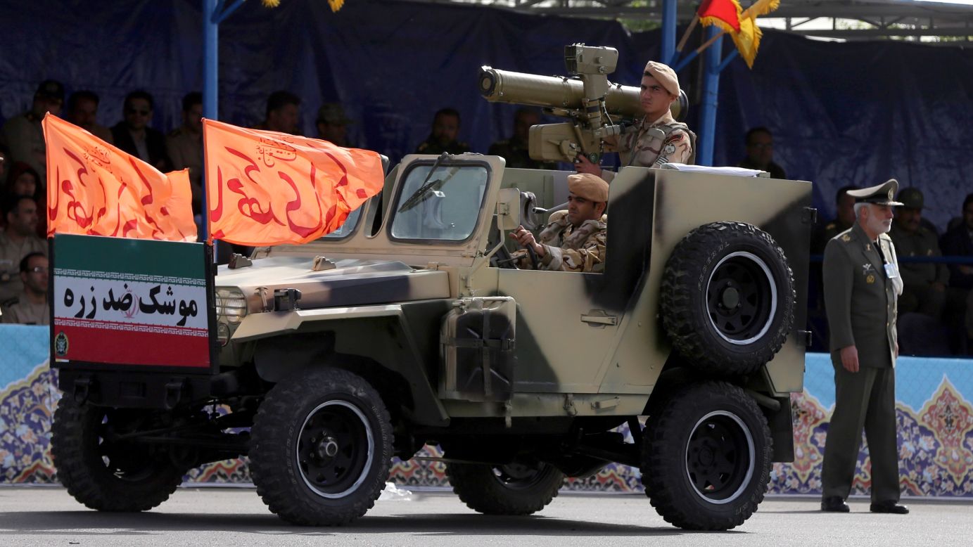 Soldiers drive a military vehicle through the parade.