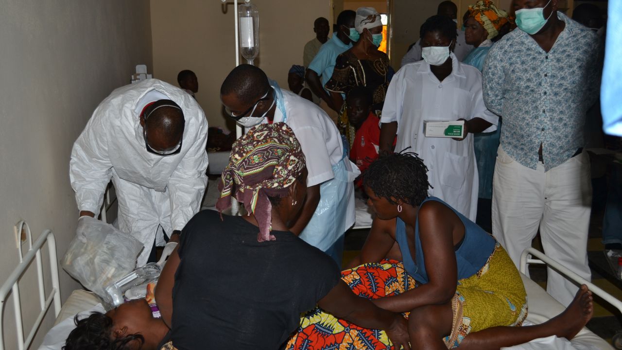 This file photo shows doctors and nurses treating a victim of alcohol poisoning in Mozambique on January 12. Authorities suspected a contaminated home brew was the cause.
