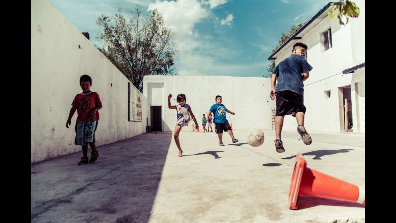 Paris-born, Argentina-raised Sebastian Gil Miranda created documentary series "Shoot Ball, Not Gun" with as part of the Buenos Aires education project "Uniendo Caminos." The images depict children who live surrounded by drug-related violence but find calm playing football in a chapel yard on the edge of Buenos Aires. 