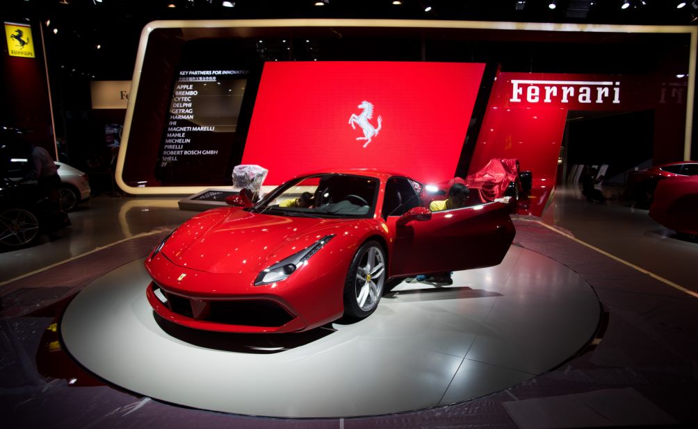 A worker cleans a Ferrari ahead of the 16th Shanghai International Automobile Industry Exhibition in Shanghai. 