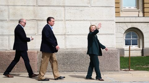 Democratic presidential hopeful and former Secretary of State Hillary Clinton, right, waves as she leaves the Iowa State Capital following a meeting with members of the Iowa State legislature on April 15, 2015 in Des Moines, Iowa. 