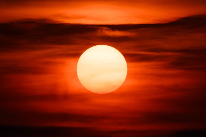 A reddish sun warms the Seattle skyline. The intense sunsets in the Pacific Northwest over the weekend were the result of smoke from wildfires burning in Siberia.
