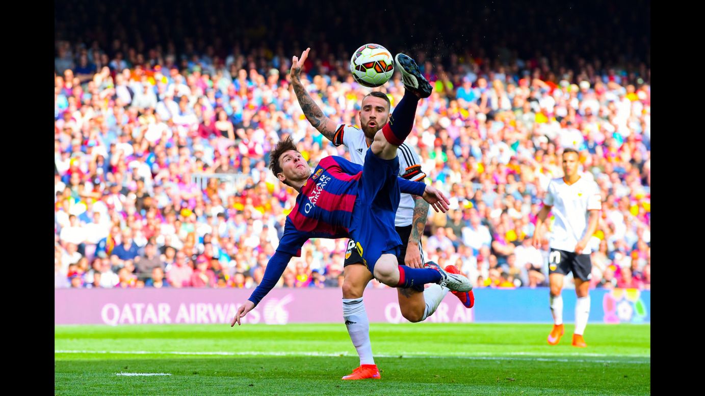 Barcelona's Lionel Messi performs an overhead kick during a Spanish league match against Valencia on Saturday, April 18. Barcelona won the home match 2-0, and Messi scored his 400th goal for the club.