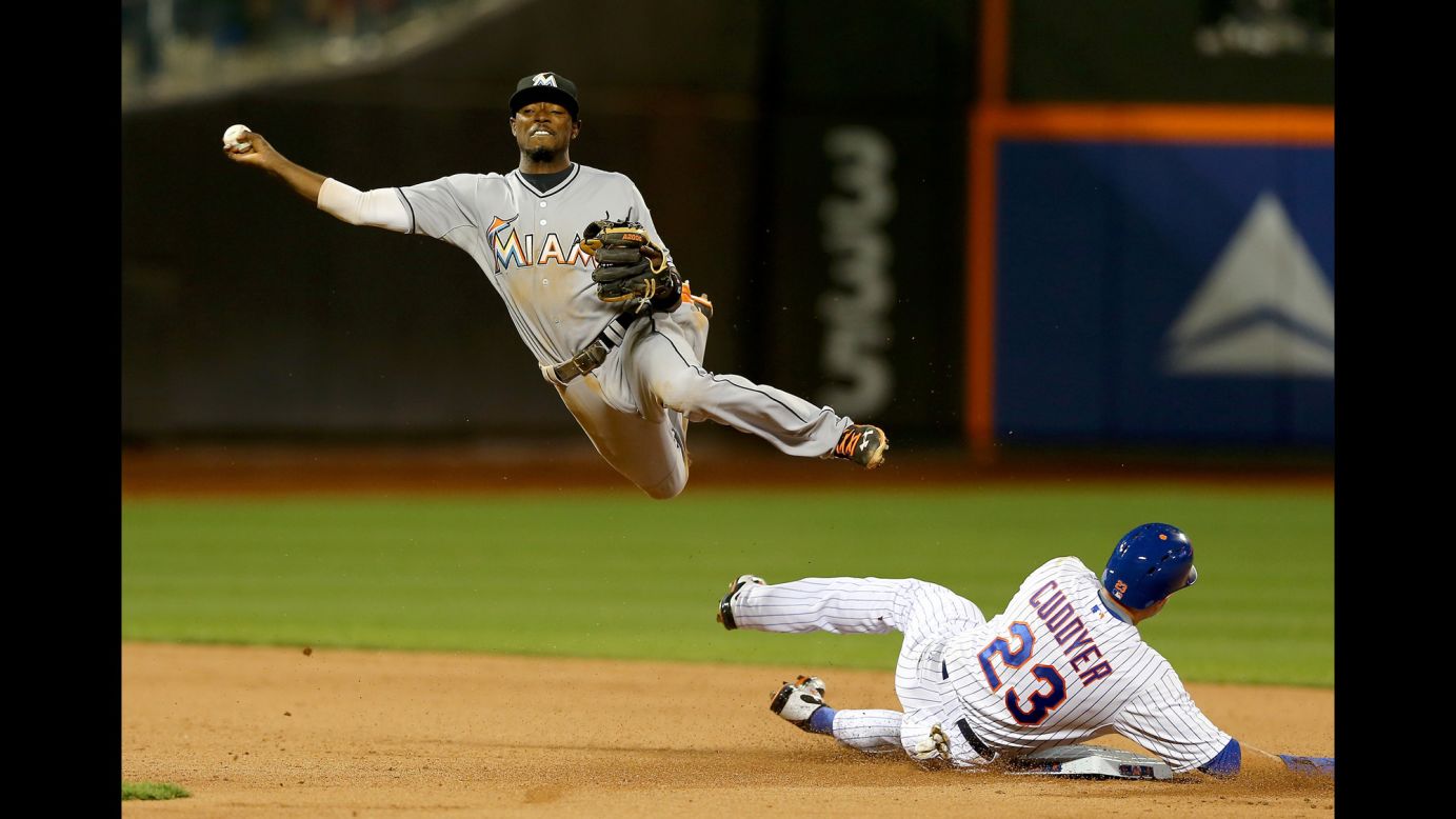 Miami's Dee Gordon tries to turn a double play while playing the New York Mets on Saturday, April 18.
