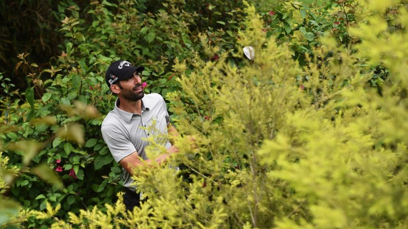 Alvaro Quiros plays a shot from the bushes Sunday, April 19, during the final round of the Shenzhen International in Shenzhen, China. He still managed to shoot a 63 and finish the tournament tied for 15th.