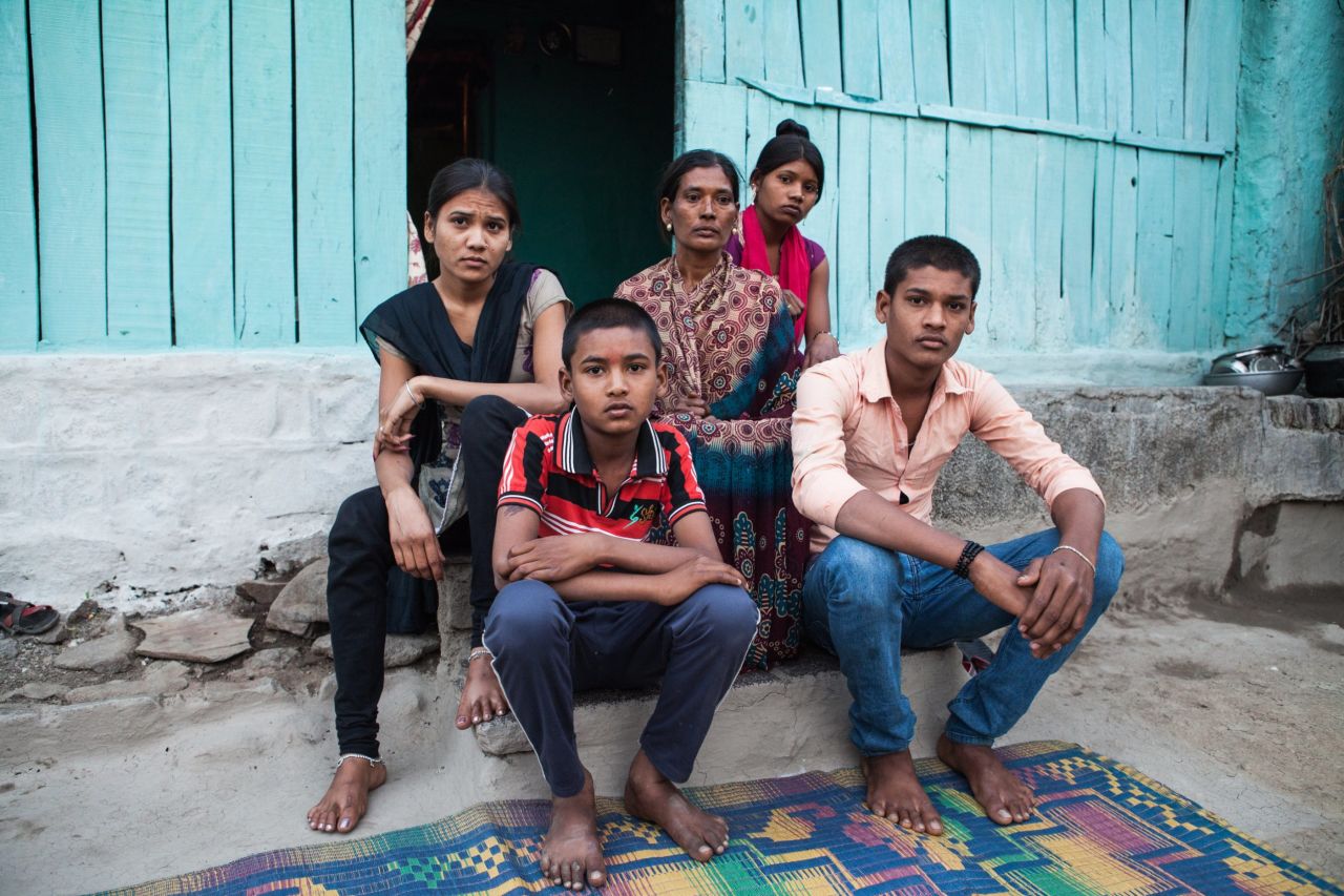 Manda Shastrakar sits with her family on the steps of her home in Vidarbha. Her husband committed suicide on January 14 this year. He doused himself with kerosene and set himself alight. He died near the steps where the family now sits. His family says he was was under pressure to repay hefty debts.