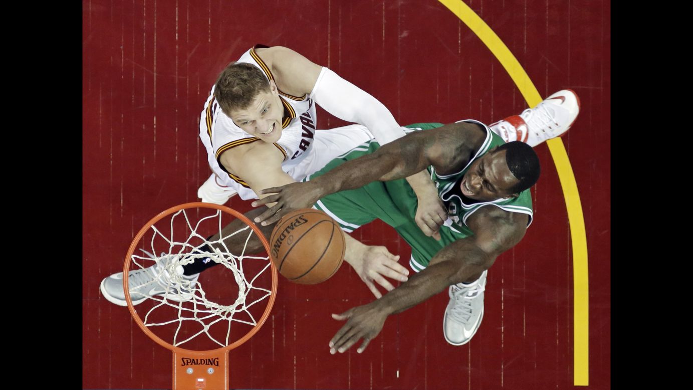 Boston's Brandon Bass, right, is defended by Cleveland's Timofey Mozgov on Sunday, April 19, during Game 1 of their Eastern Conference playoff series. Cleveland won the home game 113-100.