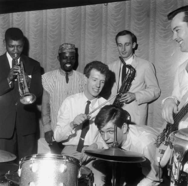 British rhythm and blues singer and keyboard player Georgie Fame (foreground, second from right) and his band The Blue Flames at the Flamingo Club, Soho, London, May 1964. Left to right: Eddie Fountain, Speedy Sacquaye, Red Reece, Mike Eve. 