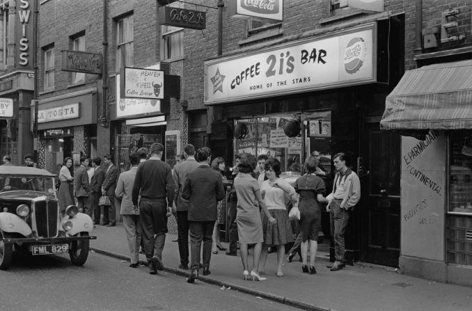 A group of young people outside the 2i's coffee bar in Soho, London, April 1961. Coffee 2i's was the birthplace of British rock n' roll.