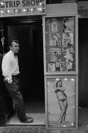 A man at the entrance to a strip club in Soho, London, April 1961. Soho was the heart of London's sex trade. 