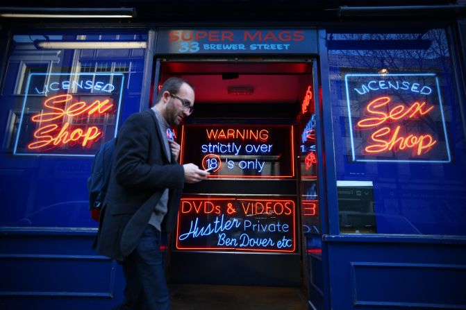 A man walks past a sex shop in Soho in 2015. A growing number of campaigners, including Stephen Fry, are pushing developers and representatives of Westminster Council to preserve the area's unique identity, which they fear is being lost as the area is gradually redeveloped.