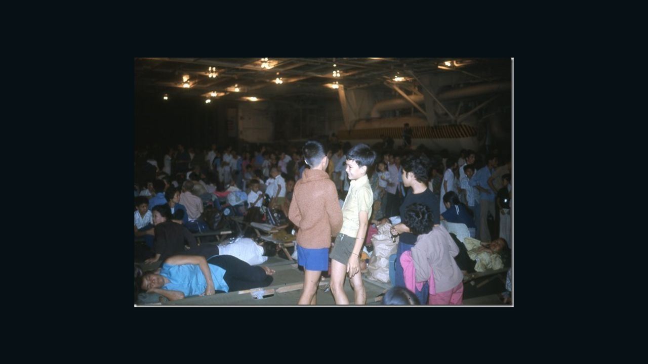 Saigon evacuees pass the time below deck on the Navy carrier USS Hancock in April 1975.