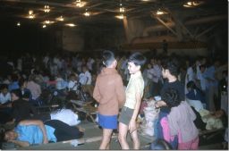 Saigon evacuees pass the time below deck on the Navy carrier USS Hancock in April 1975. 