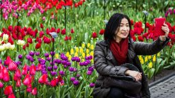 A woman poses for a selfie in front a field of tulips in the Keukenhof flower garden, also known as the Garden of Europe, in Lisse, The Netherlands, on March 21, 2015. Keukenhof is the second largest flower garden in the world.