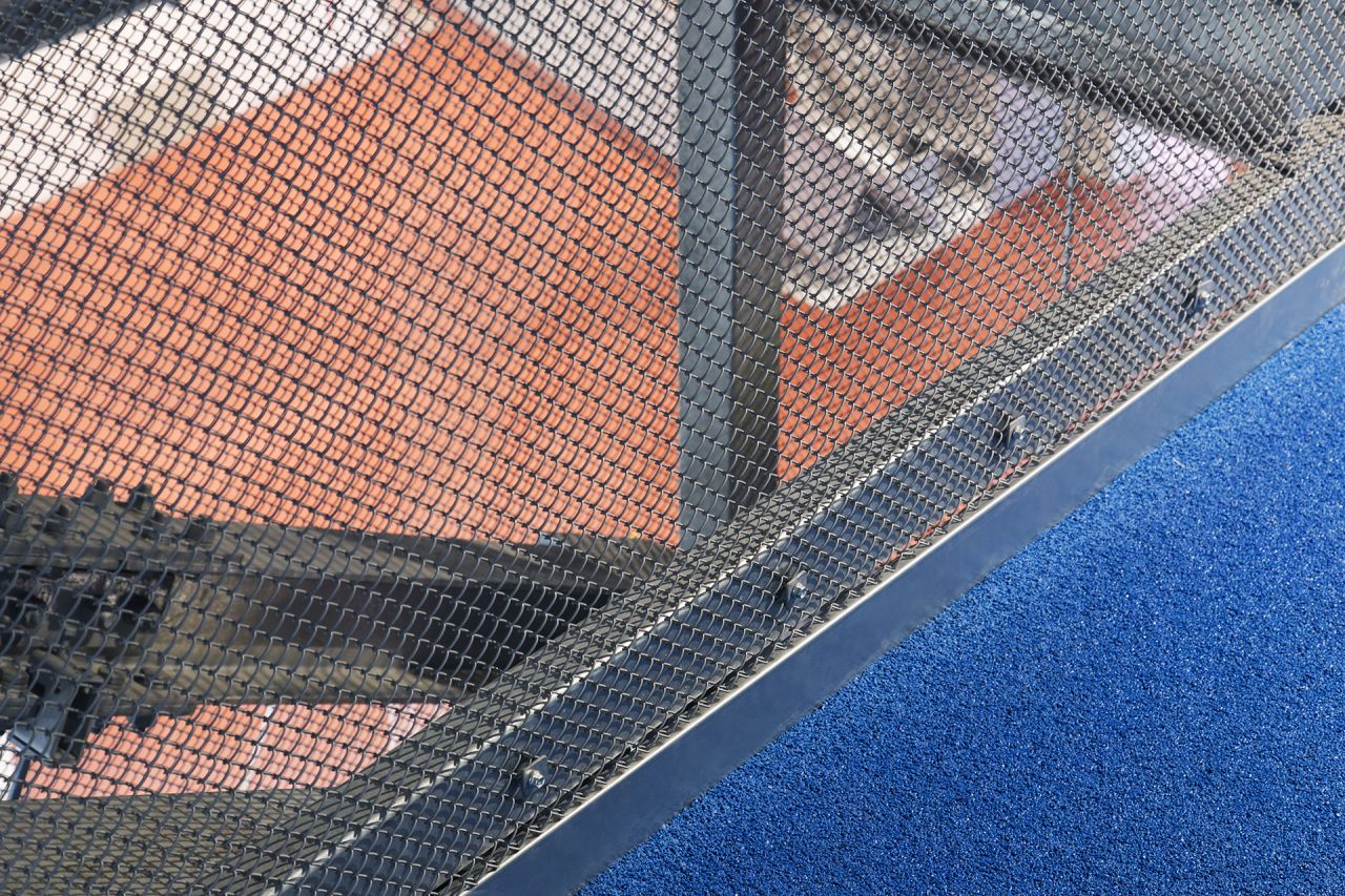 Across the terminal, which exclusively serves budget carriers, low-cost features can be found where expensive ones are expected. Here, wire mesh replaces glass.