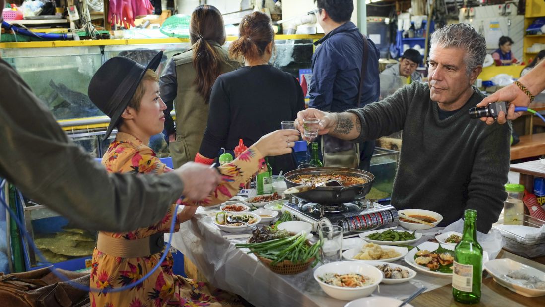 Anthony Bourdain meets with his friend and colleague Nari Kye at Garak Market in Seoul, South Korea. The eating stalls at the fish market are just the way Tony and Nari like it: full of wet floors, shouting servers, self-service soju and still wriggling seafood. 