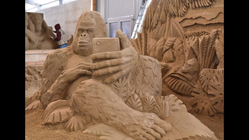 A gorilla is taking a selfie in this sand sculpture made by Ivan Zverev in Elstal, Germany.