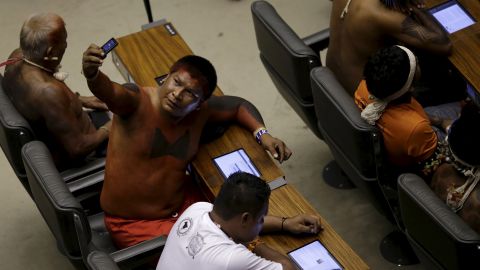 A Brazilian from a indigenous group takes a selfie as he sits in the Chamber of Deputies, the lower house of Brazil's legislature, on Thursday, April 16. Brazilian Indians from several ethnic groups are gathering in the country's capital of Brasilia to attend the National Indigenous Mobilization, which aims to discuss issues of land demarcation and indigenous rights.