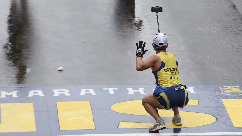 A runner squats down to take a selfie as he crosses the Boston Marathon finish line on Monday, April 20.<a href="http://www.cnn.com/2015/04/15/living/gallery/look-at-me-selfies-0415/index.html" target="_blank"> See 27 selfies from last week</a>