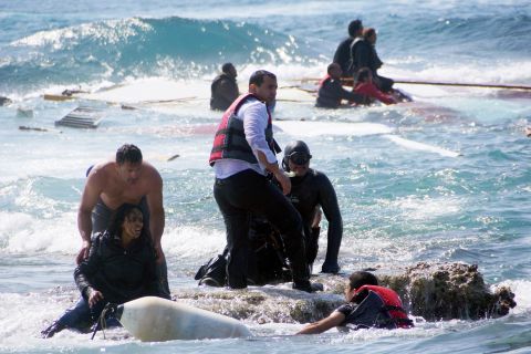 Migrants are rescued from the Aegean Sea, off the coast of the Greek island of Rhodes, on Monday, April 20. Greek authorities said that at least three people died after their wooden boat ran aground. 