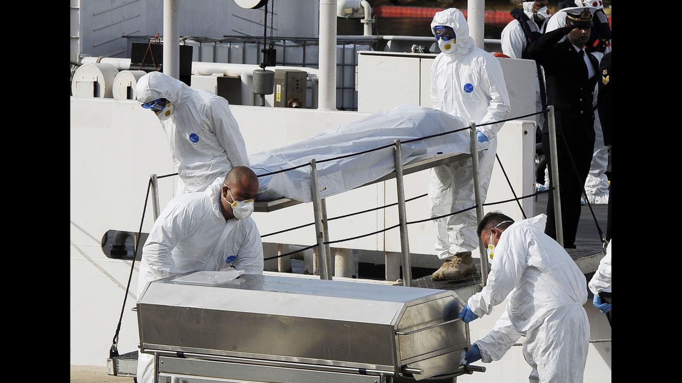 Italian Coast Guard officers carry the body of a dead migrant off a ship in Valletta, Malta, on April 20. A smuggler's boat crammed with hundreds of people overturned off Libya's coast as rescuers approached on Saturday, April 18, causing what could be the Mediterranean Sea's deadliest known migrant tragedy. Hundreds of migrants are believed to have perished as they attempted to cross the Mediterranean from Libya to Italy.