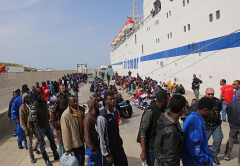 Migrants wait to board a cruise ship as they leave the Italian island of Lampedusa on Friday, April 17.