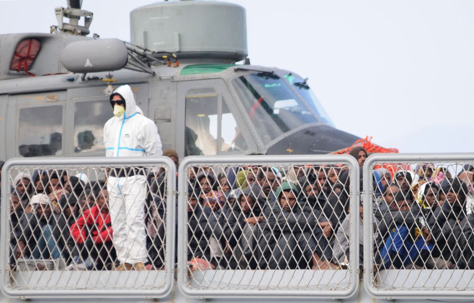 Rescued migrants wait to disembark from an Italian Navy vessel in the harbor of Reggio Calabria, Italy, on Tuesday, April 14. The European Union is expected to unveil a new strategy aimed at tackling the migrant wave in late May.
