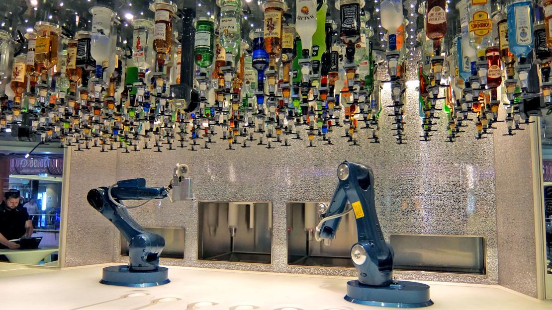 Bottles overhang the robot bartenders as they mix up tomorrow's hangovers.