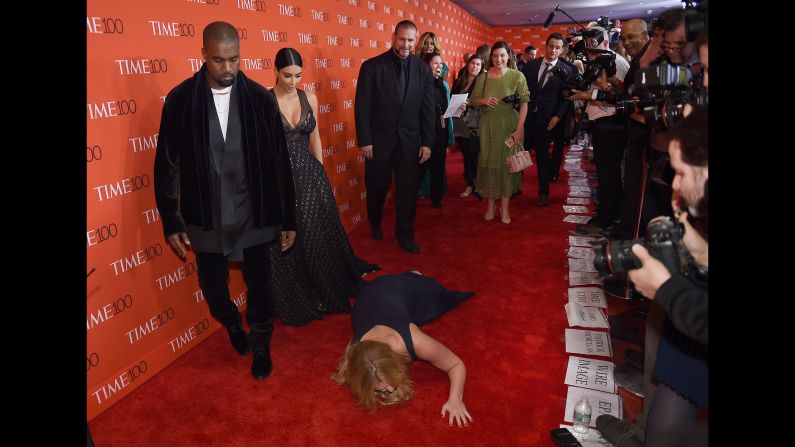 Honoree and comedian Amy Schumer pretends to trip and fall on the red carpet in front of fellow honorees Kim Kardashian and Kanye West at the TIME 100 Gala Tuesday night in New York.
