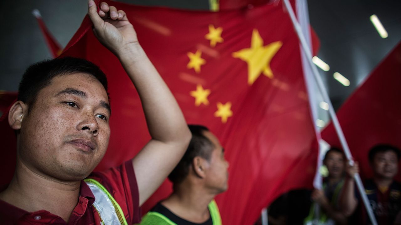 Pro-government protesters wave Chinese national flags outside the Legislative Council on April 22, 2015 in Hong Kong.