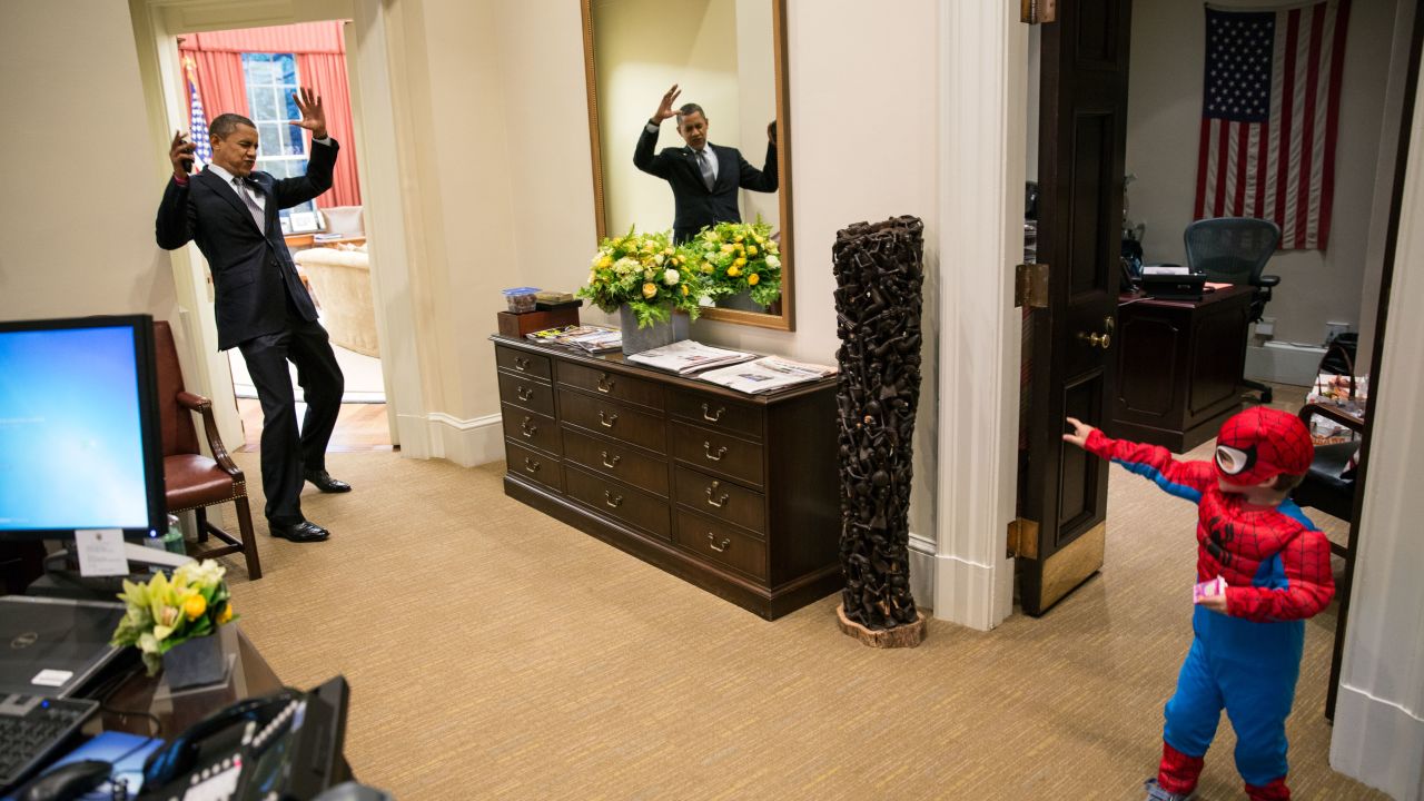 President Obama pretends to be caught in Spider-Man's web as an aide's son goes trick-or-treating.