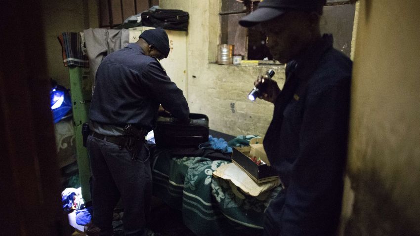 Policemen proceed with a search for drugs and weapons during a South African Police and South African army raid in Johannesburg on April 21, 2015. South African soldiers deployed overnight to tackle gangs hunting down and killing foreigners after at least seven people died in a wave of anti-immigrant violence. AFP PHOTO / MARCO LONGARIMARCO LONGARI/AFP/Getty Images
