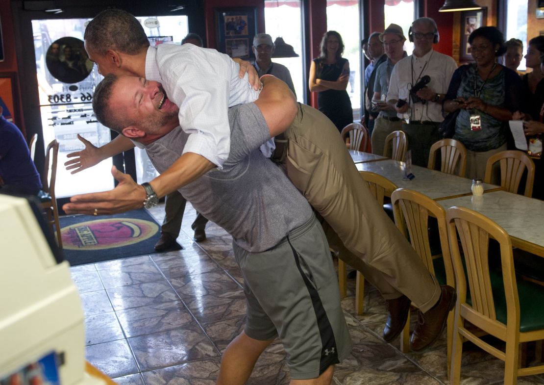 Restaurant owner Scott Van Duzer lifts the president during a Florida campaign visit in 2012.