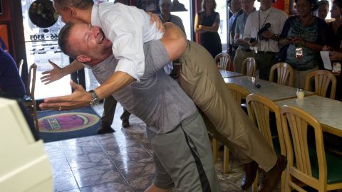Restaurant owner Scott Van Duzer lifts the president during a Florida campaign visit in 2012.