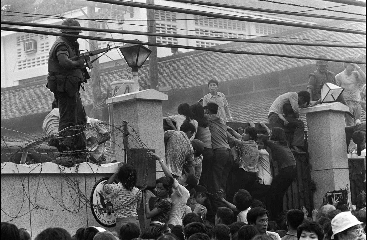 Mobs of Vietnamese people scale the wall of the U.S. Embassy in Saigon on April 29, 1975, trying to get to a helicopter pickup zone. A day later, South Vietnam surrendered to North Vietnam when North Vietnamese troops entered Saigon. Saigon is now called Ho Chi Minh City in honor of the late North Vietnamese leader.