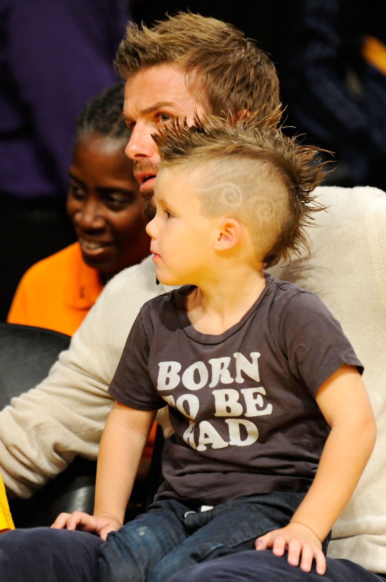 Like father, like son: the Beckhams' third offspring Cruz with his dad at an NBA game in LA in 2009.