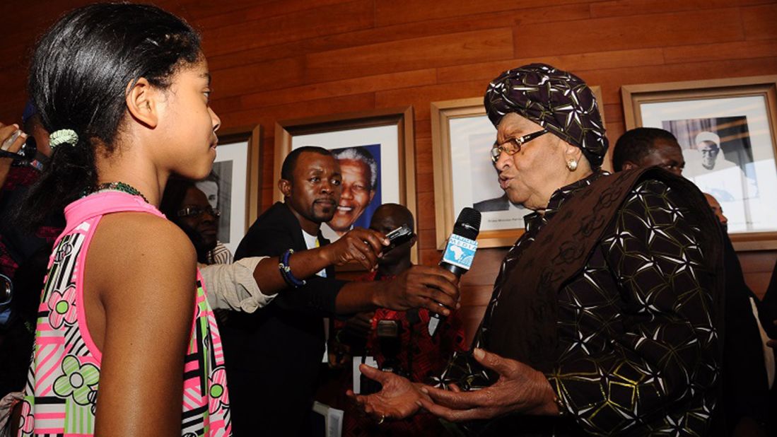 Zuriel Oduwole gets into the media scrum while interviewing Ellen Johnson Sirleaf, president of Liberia.