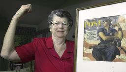 Mary Doyle Keefe poses with the 1943 cover of the Saturday Evening Post for which she had modeled as "Rosie the Riveter" in a Norman Rockwell painting.
