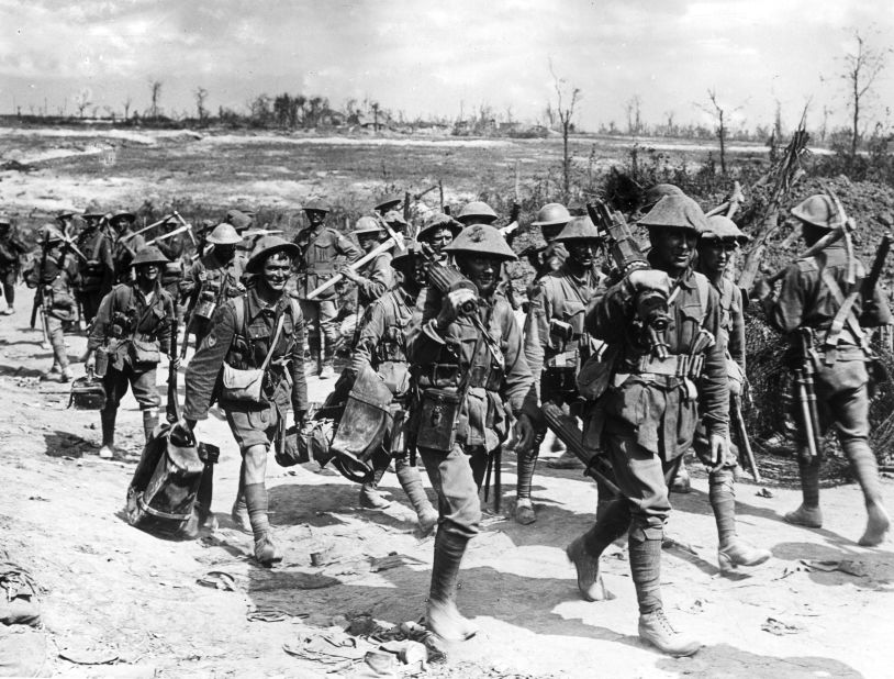 In a photo dated 1916,  Australian machine gunners march on a dirt road back from the front line trenches towards their billets, France, World War I.