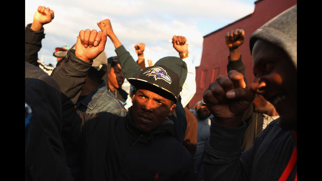 Demonstrators put their fists in the air during a protest outside the Baltimore police's Western District station on Wednesday, April 22.