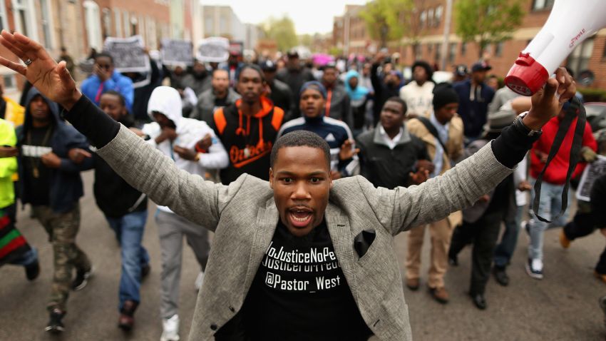 Hundreds of demonstrators march toward the Baltimore Police Western District station on April 22.