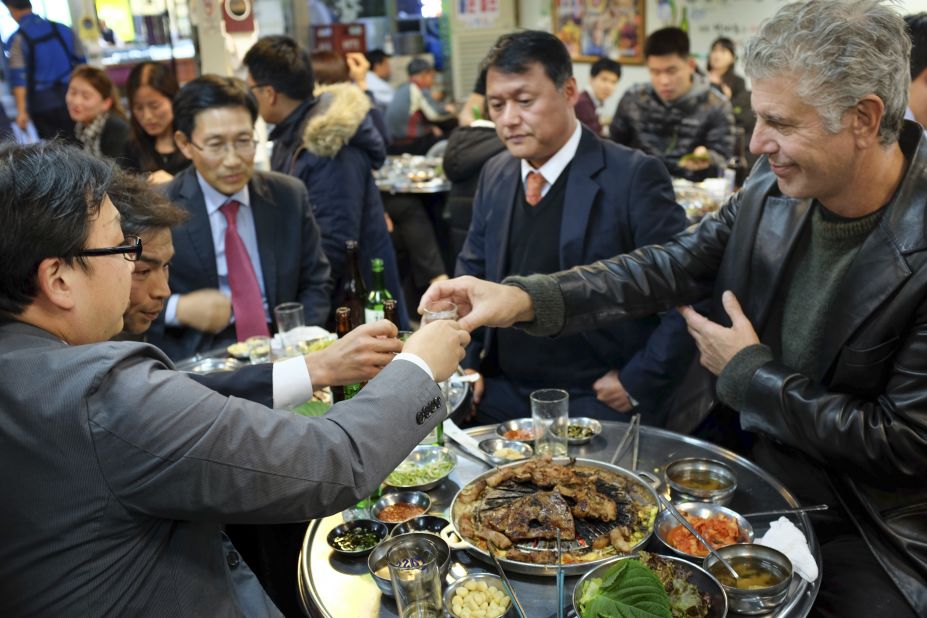 Tony befriends a group of businessmen for some Korean barbecue at Mapo Jeong Daepo. Most restaurants also offer a variety of banchan, or free small dishes, with the meal.