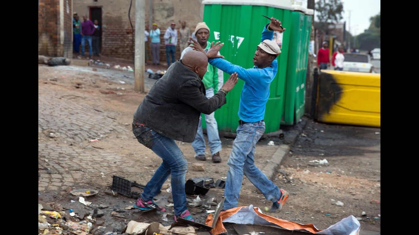 Mozambican Emmanuel Sithole, left, was walking down a street in Johannesburg's Alexandra Township when four men surrounded him on Saturday, April 18. Sithole pleaded for mercy, but it was already too late. The attackers bludgeoned him with a wrench and stabbed him with knives, killing him in broad daylight. <a href="http://www.cnn.com/2015/04/20/world/gallery/south-africa-attack/index.html" target="_blank">Photographer James Oatway was nearby</a> and captured it all on his camera.