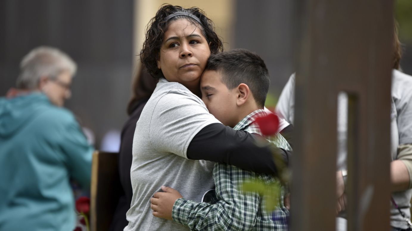 Kathy Dutton comforts her 10-year-old son, Kolby, near the memorial chair of her nephew Zachary Chavez during a ceremony Sunday, April 19, for victims of the Oklahoma City bombing. On April 19, 1995, the Albert P. Murrah Federal Building in Oklahoma City was rocked by a truck bomb. <a href="http://www.cnn.com/2013/07/26/us/gallery/crimes-of-the-century-okc-bombing/index.html" target="_blank">The terrorist attack</a> killed 168 people and injured more than 500.