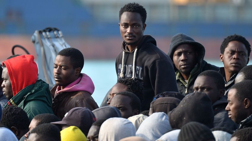 Rescued migrants stand as they disembark off the Italian Guardia di Finanza vessel Denaro at the Sicilian harbour of Catania on April 23, 2015. Calls have mounted for a military response to the Mediterranean migrant crisis, but experts say such plans are totally unworkable and mark an attempt to militarise what should be a purely humanitarian problem. European leaders will gather in Brussels to discuss new strategies in the wake of the latest disaster on April 19, in which hundreds of migrants drowned when their boat capsized on the way from Libya to Italy. AFP PHOTO / ALBERTO PIZZOLIALBERTO PIZZOLI/AFP/Getty Images