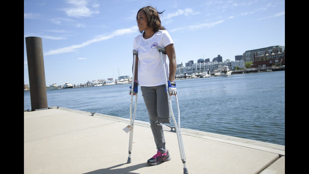 <strong>Mery Daniel</strong>, a young mother from Haiti, was attending her second marathon when she was knocked to the pavement. She lost a leg, and the other leg was also damaged. She had pushed herself from ESL classes all the way to medical school, and instead found herself relearning how to walk with a prosthesis. She wears her "Boston Strong" T-shirt proudly.